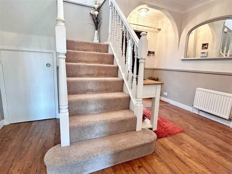 An open and inviting hallway greets visitors upon arrival