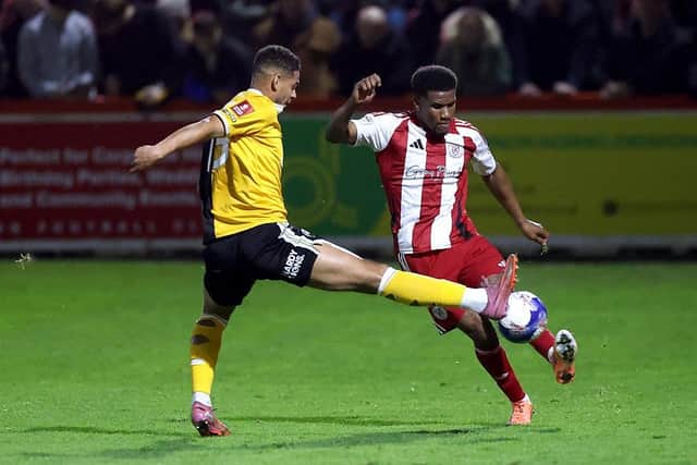 Brackley's Riccardo Calder is challenged by Burton's Kyran Lofthouse (Photo by David Rogers/Getty Images)