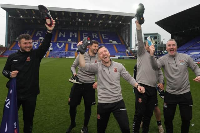 Jon Brady and the Cobblers coaching staff enjoy the team winning promotion at Tranmere Rovers in May (Photo by Pete Norton/Getty Images)
