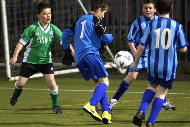 Football action from St Luke's Primary School (green), V Hunsbury Park Primary School (blue).