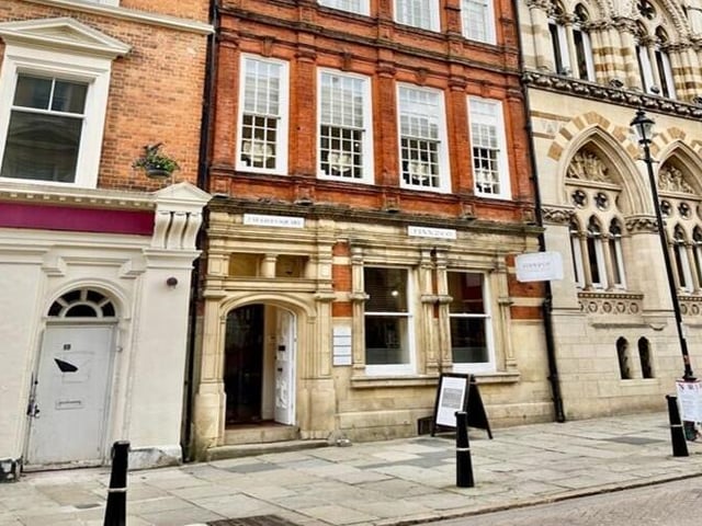 The Grade II listed property on St. Giles Square has four floors and a basement. Potential uses include shop, office, estate agent, clinic, café, restaurant, medical facility, or day centre, subject to planning. The property is available to let on a new lease for around £30,000 a year (approximately £2,500 a month).