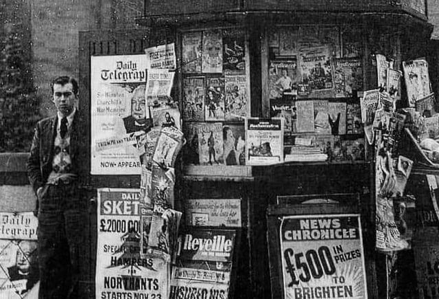 Man at his newsstand selling papers. Circa 1940s/1950s.