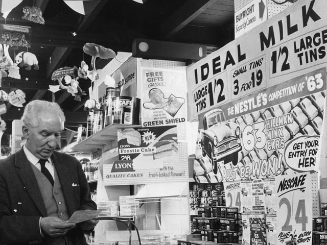April 1963, A shopper in a Northampton supermarket consults his shopping list, apparently unaware that he is being watched by a clearly labelled Buyright Security Camera. A closed circuit television monitors the shop's customers, in an attempt to combat shoplifting. (Photo by John Drysdale/Keystone/Getty Images)