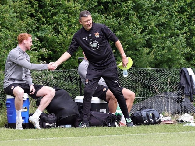 Ian Sampson shakes the hand of new signing Callum Morton