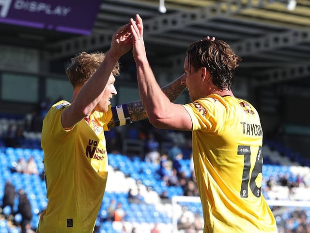 Mitch Pinnock celebrates with Terry Taylor after his free-kick is headed in by Eaves