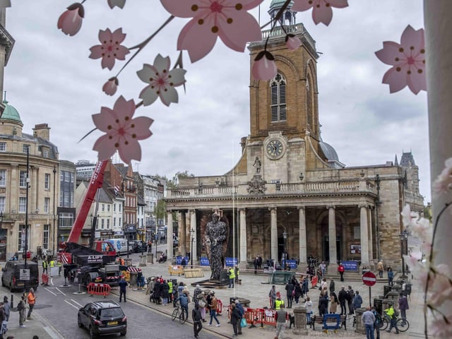 The view from across the street as the statue is carefully positioned on the plaza outside All Saints'