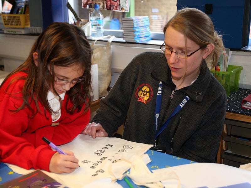 Pupils from the eco-committee at Hunsbury Park Primary School designing a logo for their own cotton bag, with some help from Kirsten Jefferies, schools waste education officer from Northamptonshire waste education team.