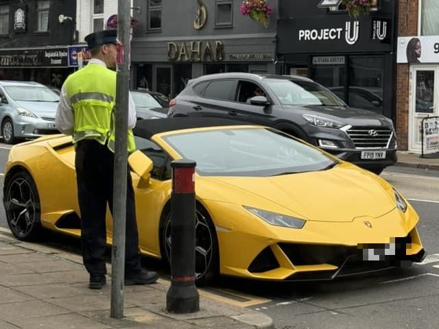 Here's the customary brightly coloured supercar, this time getting a ticket