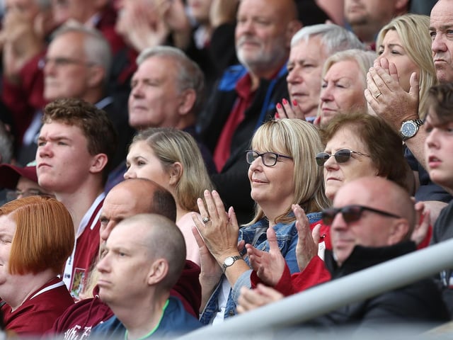 2019: Northampton Town fans observe a minutes applause in the 19th minute to honor the memory of Northampton fan Harry Dunn (19) who died in a motorbike accident on Tuesday August 27th during the Sky Bet League Two match between Northampton Town and Plymouth Argyle at PTS Academy Stadium on August 31, 2019 in Northampton, England. (Photo by Pete Norton/Getty Images)