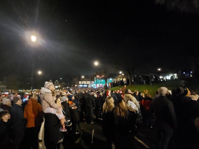 Earls Barton celebrates Christmas Eve in the Square - People look upon the impressive fireworks display