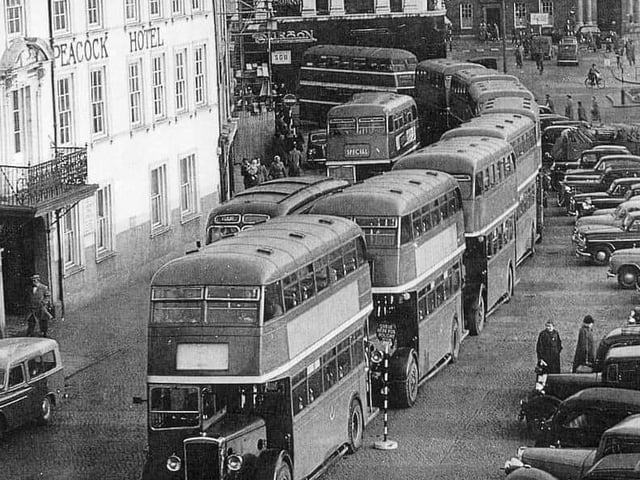 Buses queue up outside the former Peacock Hotel in Market Square. Circa 1950s/1960s.