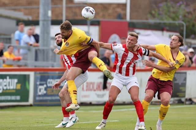 Town skipper and goalscorer Jon Guthrie challenges for a header during Saturday's game against Brackley.
