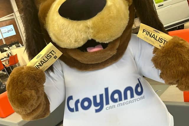Croyland’s mascot Cooper the Dog holding the NBEA Finalist Golden Tickets.