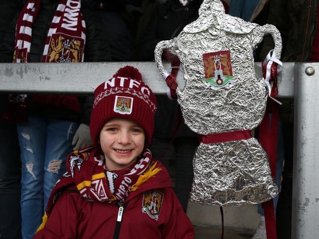 A young Northampton Town fan poses with his homemade tin foil FA Cup prior to the FA Cup Third Round match between Burton Albion and Northampton Town at Pirelli Stadium on January 05, 2020.