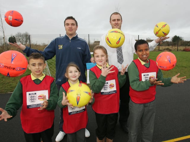 2007: Green Oaks Primary school receive a new football award from the FA. PIctured left to right are Lee Brown, Teacher Richard Albert and three pupils from each year.