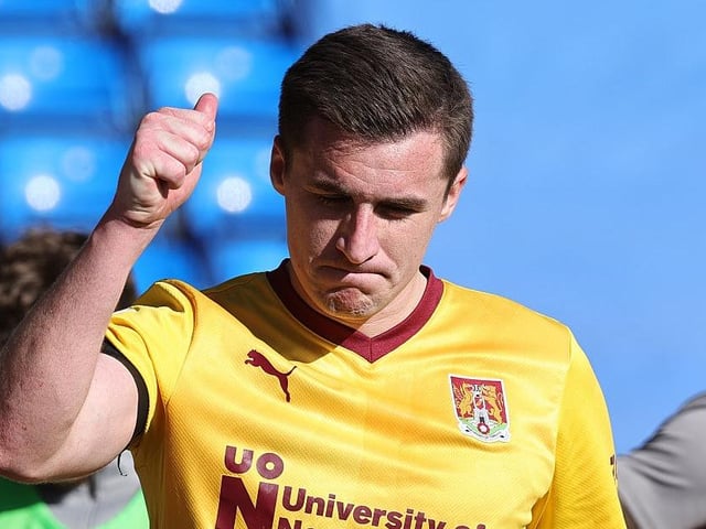 Aaron McGowan responds with a thumbs up after being serenaded by Town's fans while walking down the touchline