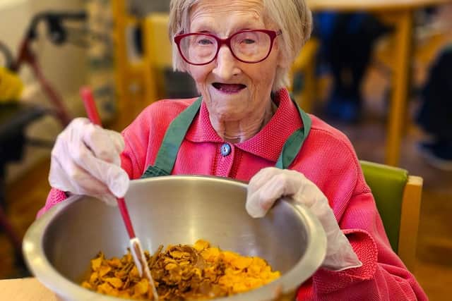 Elm Bank Care Home resident enjoying the creating of the Easter Cake