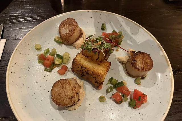 Pan-fried wild scallops with parsnip purée, tomato and spring onion salsa, dauphinoise chips.