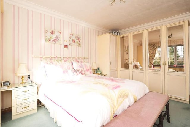 This second image of the master bedroom reveals its extensive fitted wardrobes. Coming up is its en suite......