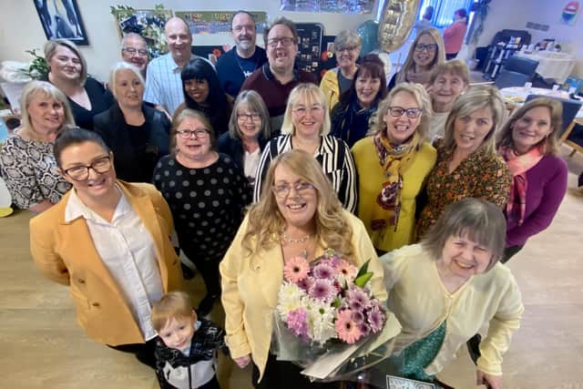 Jeanette Davies (front centre) flanked by colleagues past and present, her family and service users celebrating her retirement after 40 years