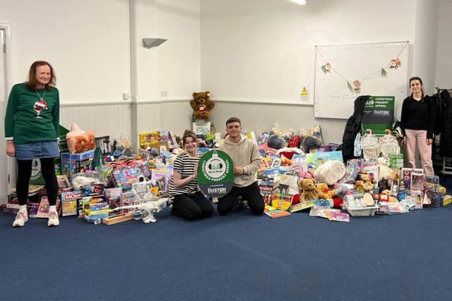 All the donated presents with Will Olerich station assistant, and NLive Radio Volunteers Amanda, Eva, Emily, and Andy