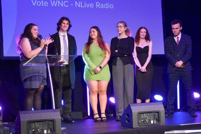 The team of students step onto the stage to collect their award.