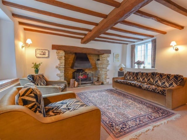 The lounge centres a large beamed mantel and attracts light from windows on both sides