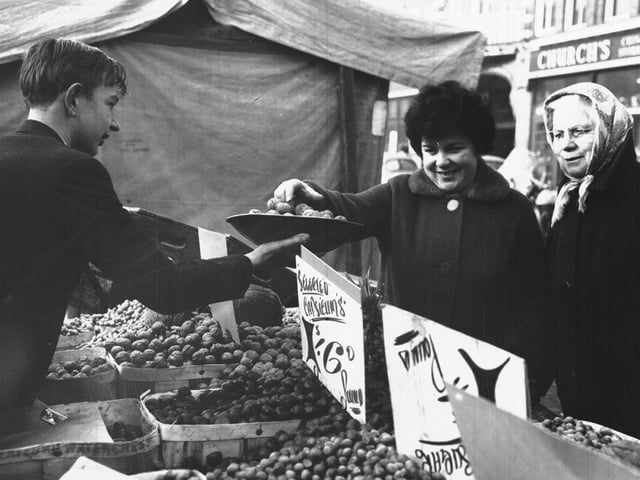 Ladies buying walnuts at Northampton Market
