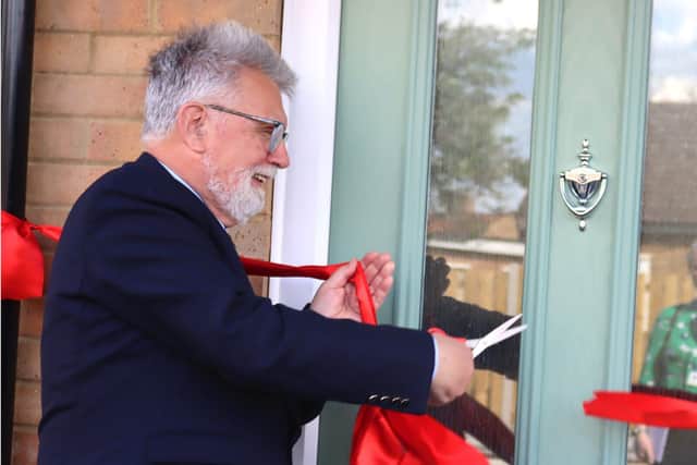 Counsellor Stephen Hibbert cuts the ribbon at the new council homes