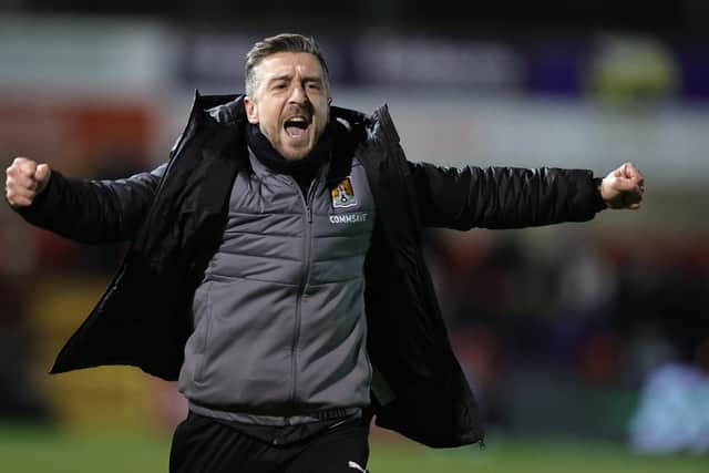 Cobblers boss Jon Brady, who has signed a new contract, celebrates the recent win at Lincoln City (Picture: Pete Norton/Getty Images)