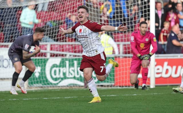 Sam Hoskins runs away to celebrate his dramatic late equaliser for the Cobblers against Newport County (Picture: Pete Norton)