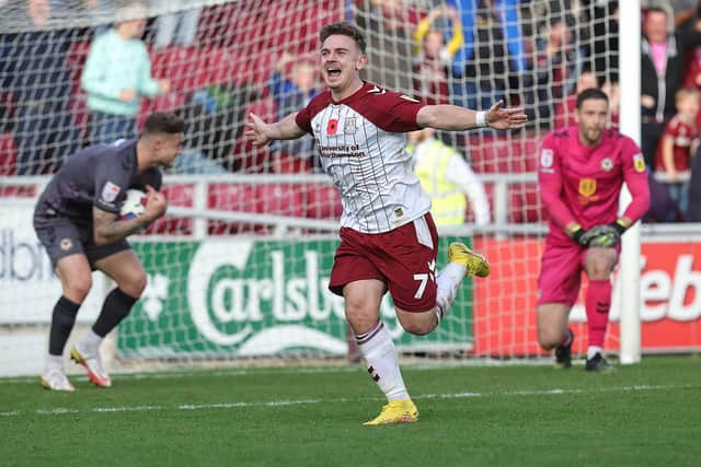 Sam Hoskins runs away to celebrate his dramatic late equaliser for the Cobblers against Newport County (Picture: Pete Norton)