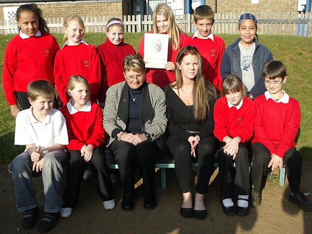 Blackthorn Primary School has received a £2000 cheque and a certificate from Woolworths to improve their playground, after entering a competition. Pictured: Sharon White, assistant head and Emma Leach, play leader, with pupils.