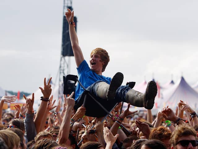 A music fan crowd surfs on a camping chair at  Reading Festival  (Photo by Simone Joyner/Getty Images)