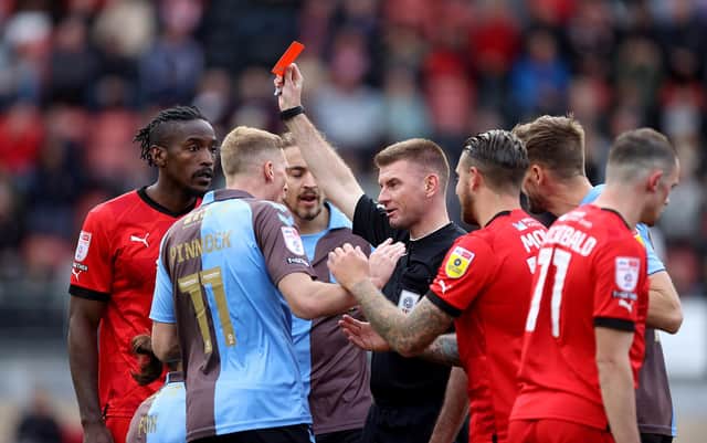 Ollie Yates shows Ben Fox a straight red card.