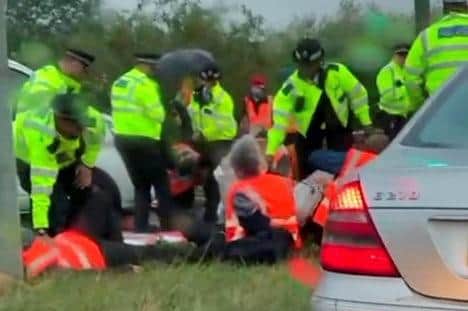 Police arrest Insulate Britain protestors blocking the M25 in September — five activists from Northampton are due in court later this month
