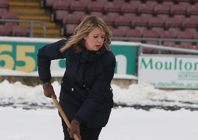 Fans clear snow from the pitch in an attempt to allow the npower League Two match between Northampton Town and Burton Albion to go ahead at Sixfields Stadium on January 19, 2013.