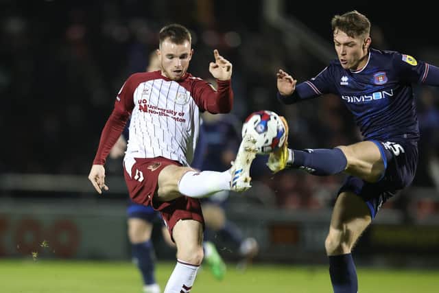 Marc Leonard challenges for the ball during the Cobblers' clash with Carlisle United (Picture: Pete Norton)