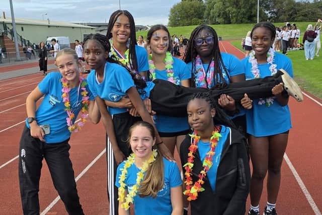 Some of R&N's Under-14 girls athletes celebrate the team's success in Liverpool