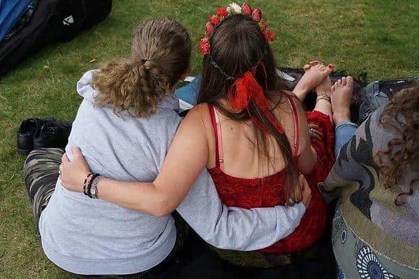 Audience members enjoying the poetry in the sunshine.