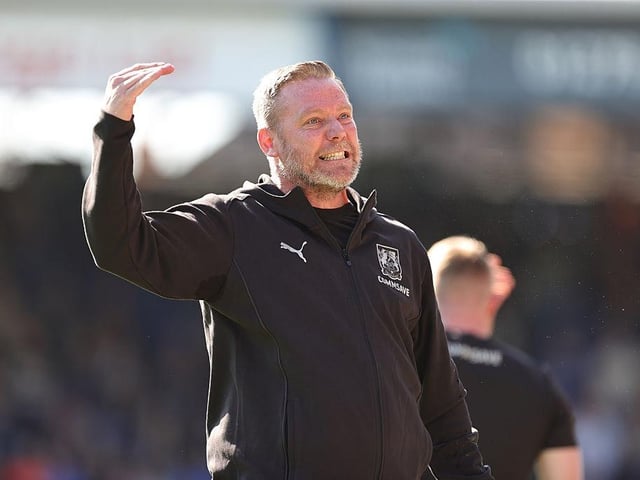 Kevin Nolan turns to celebrate towards the Cobblers fans after Sam Hoskins made it 2-0 from the penalty spot