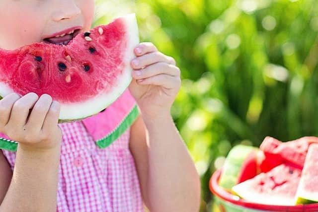 A child eating a watermelon slice