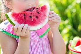 A child eating a watermelon slice