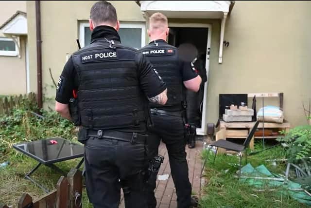The home was one of two raided in Corby. Police found guns, swords, drugs and cash during the planned raid.
