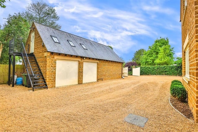 This modern family home is in a picturesque village and shares its boundary with a church.