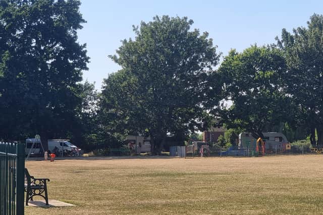 Around five caravans and vans were parked next to the children's play area in Wootton Fields on Wednesday (July 8)
