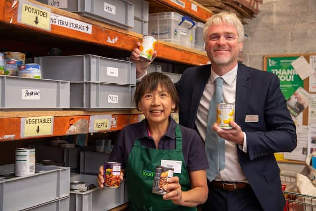 DWSM - SGB-48086 - Daniel helping Peggy of Towcester Foodbank sorting some stock