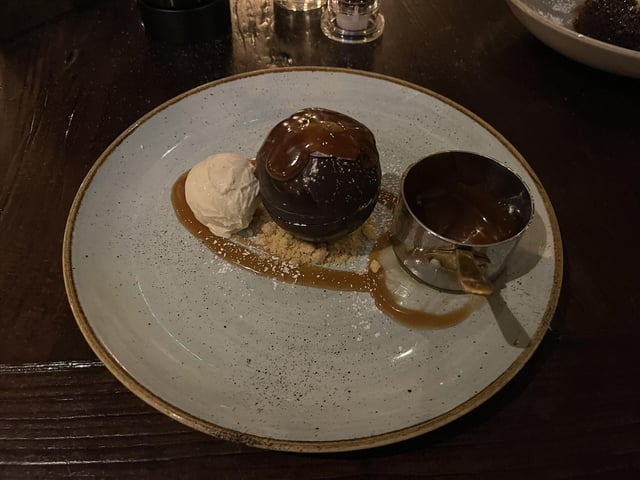 Chocolate bomb with chocolate brownie, Biscoff spread, vanilla ice cream, hot toffee sauce.