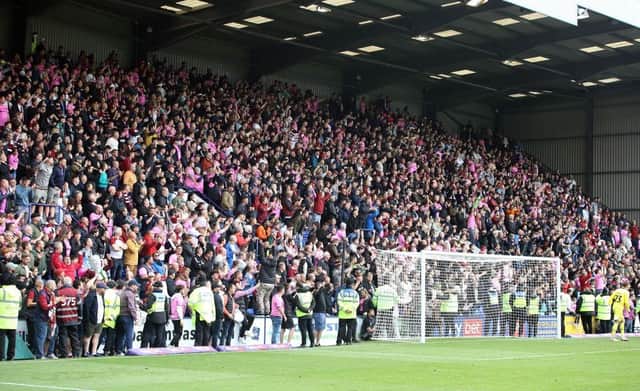 The away end at Prenton Park was awash with pink shirts as well over 2,000 Cobblers fans roared their side onto promotion. Pictures: Pete Norton.