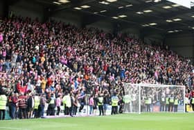 The away end at Prenton Park was awash with pink shirts as well over 2,000 Cobblers fans roared their side onto promotion. Pictures: Pete Norton.